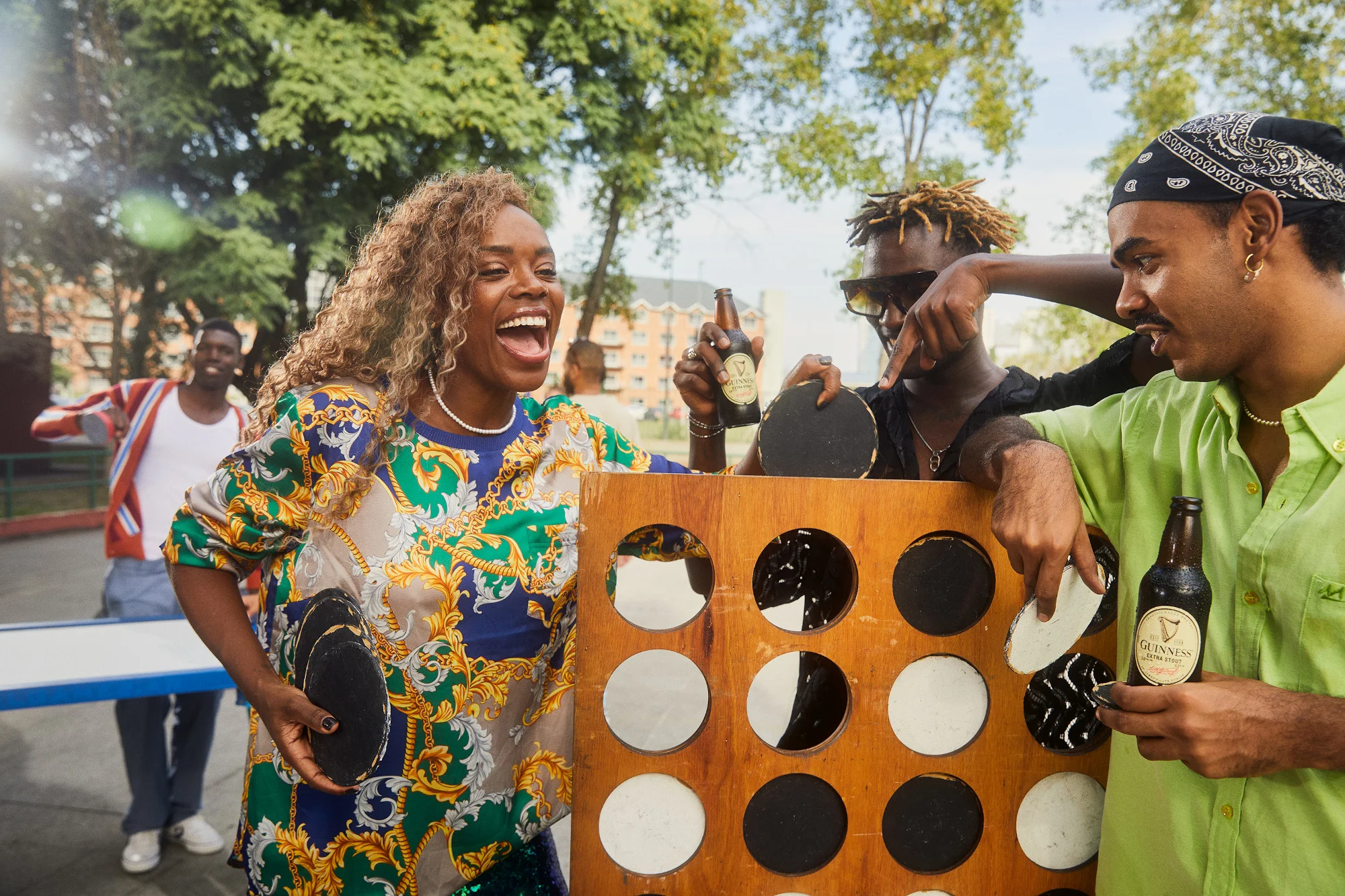 People with Guinness bottles, playing a game